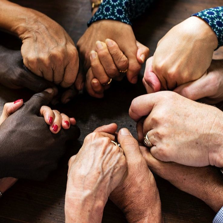 Hands joined in a circle - representing community support and healing
